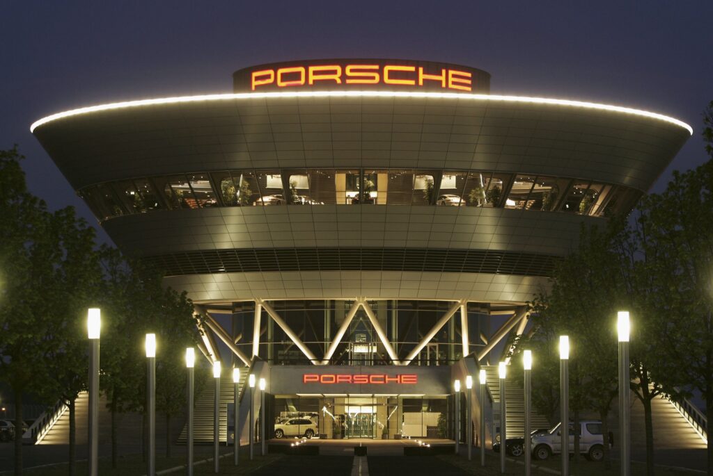 Logo von Porsche über dem Eingang zu einem Geschäft bei Nacht